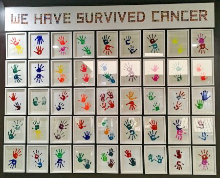 Wall of children's hand prints who were given life-saving eye cancer treatment by Operation Eyesight