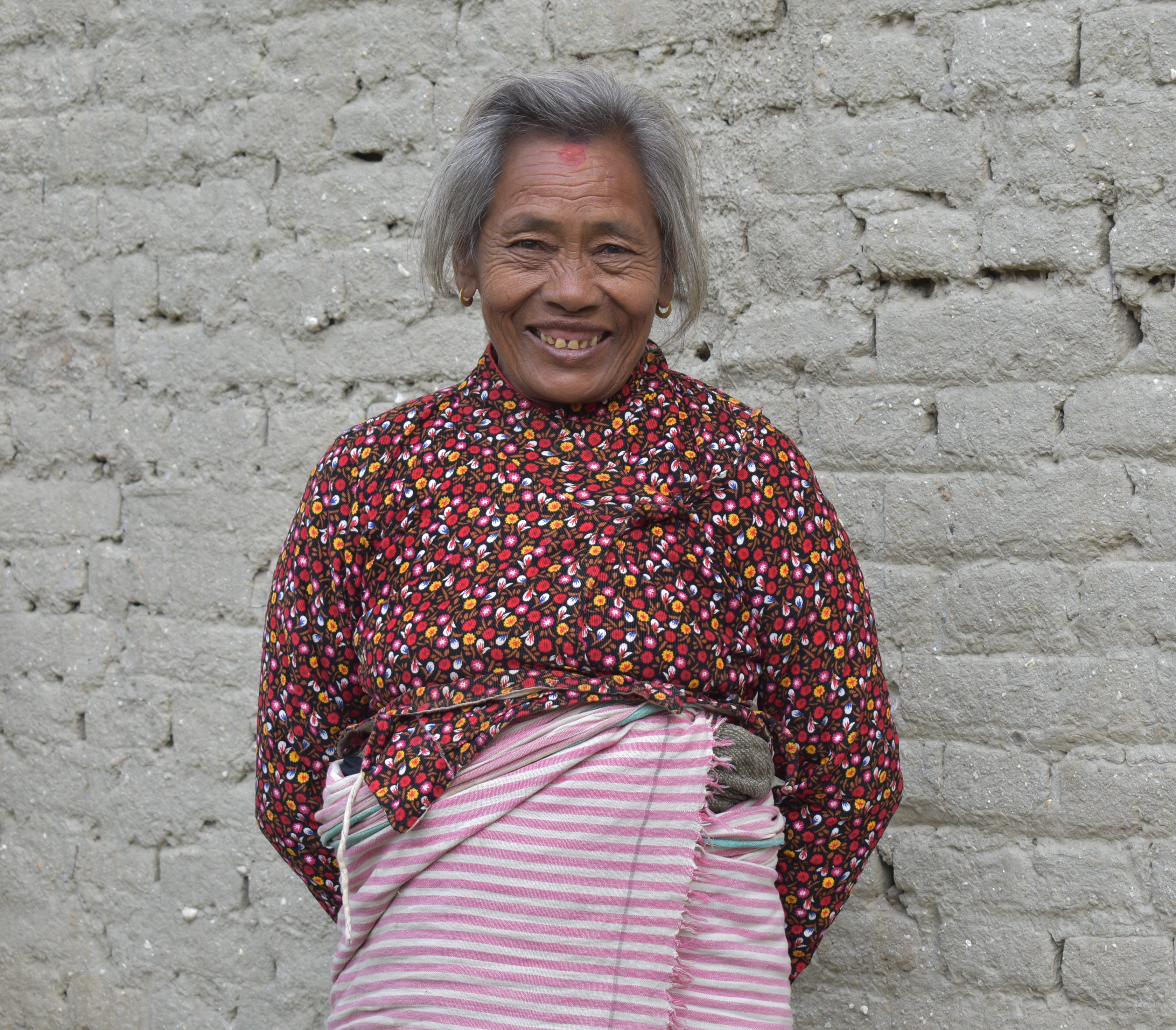 Woman from Nepal smiling happily into the camera now that her sight has been restored