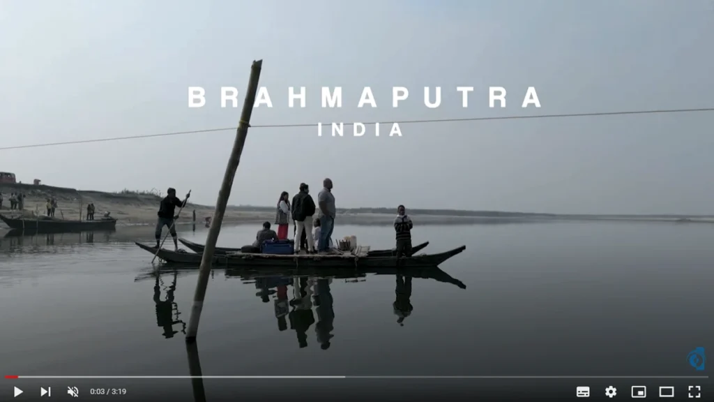 Screenshot from YouTube shows a video of a boat on a river with the words, "Brahmaputra, India" written on the screen.