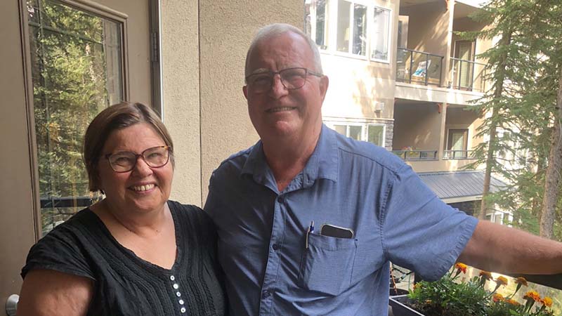 A husband and wife stand