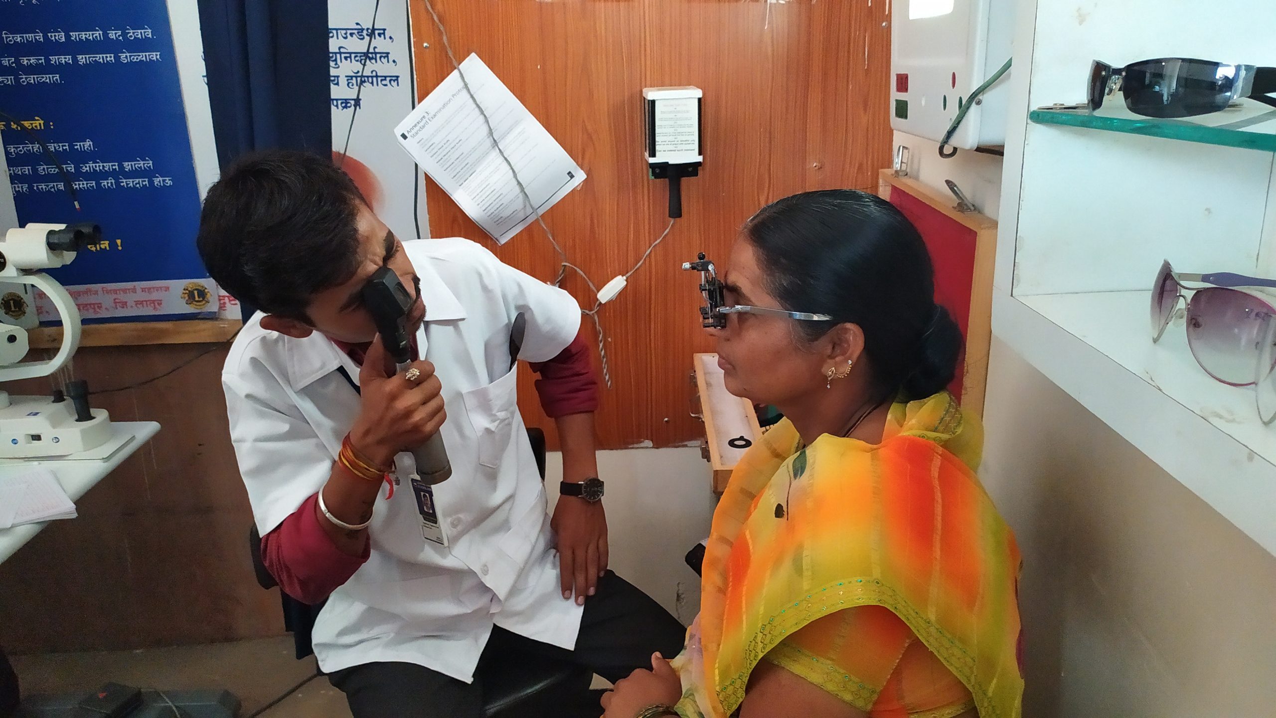 Chikhale performs a retinoscopy on a patient being screened to receive eyeglasses.