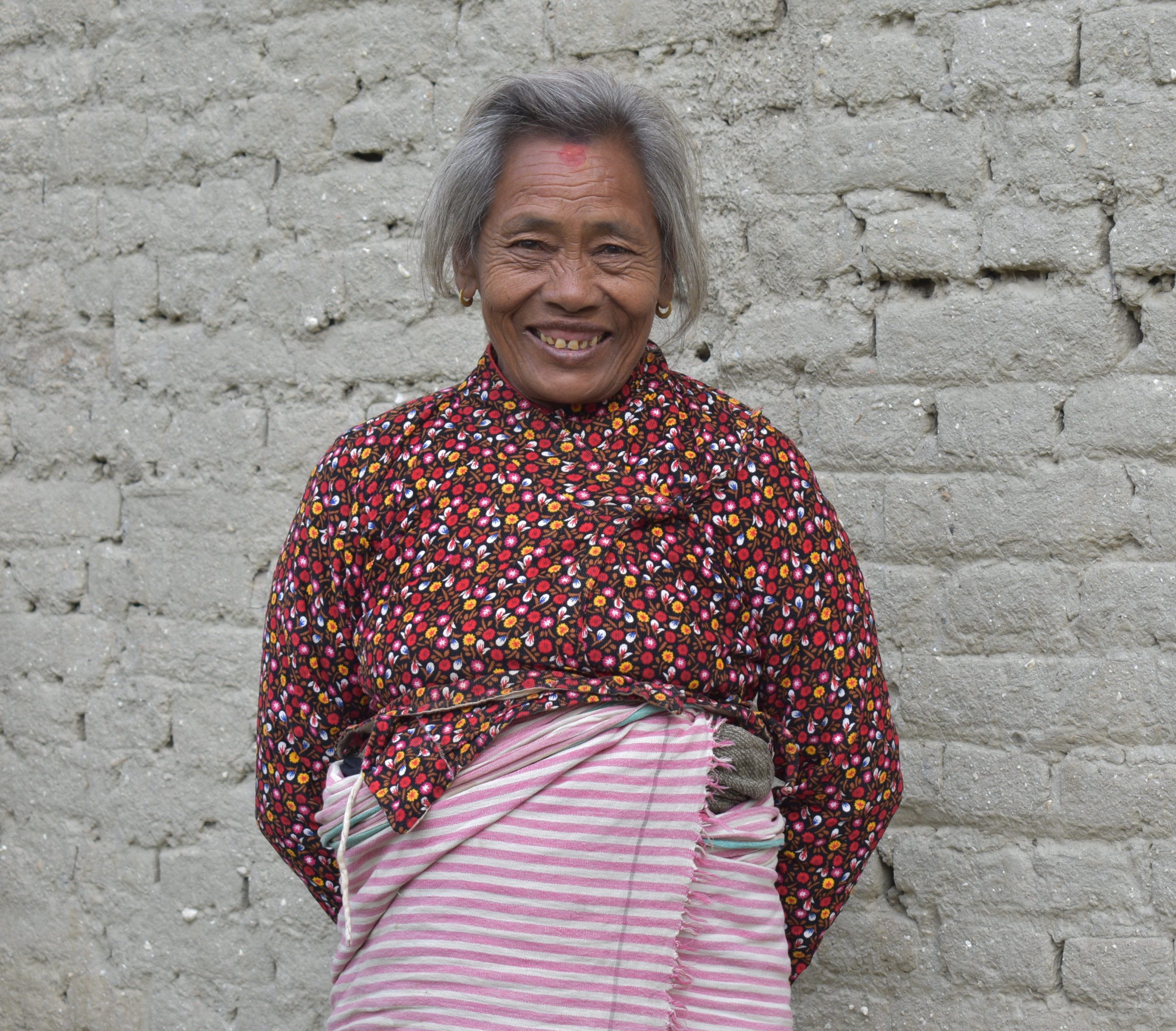 Woman from Nepal smiling happily into the camera now that her sight has been restored|Woman from Nepal receives sight-saving surgery thanks to Operation Eyesight donors