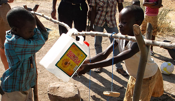 Kenya COVID-19|young girl getting water from water jug