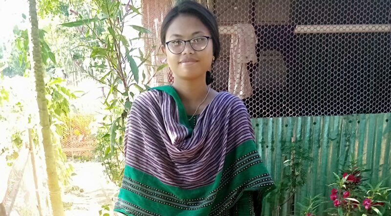 Woman from Bangladesh wearing a green sari smiles for the camera